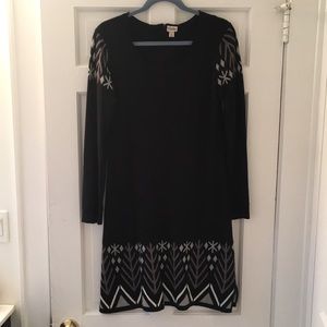 Long-sleeved black sweater dress with snowflake details on hem and shoulders
